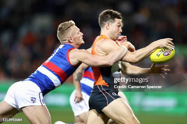 Toby Greene of the Giants is tackled by Adam Treloar of the Bulldogs during the round six AFL match between the Greater Western Sydney Giants and the...