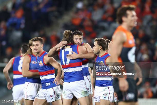 Marcus Bontempelli of the Bulldogs celebrates with team mates after kicking a goal during the round six AFL match between the Greater Western Sydney...