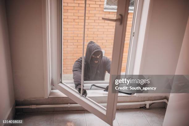 Robber Breaking In Burglar Entering House Photos and Premium High Res Pictures - Getty Images
