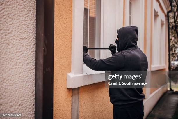 robber trying to brake in house - breaking and entering stock pictures, royalty-free photos & images