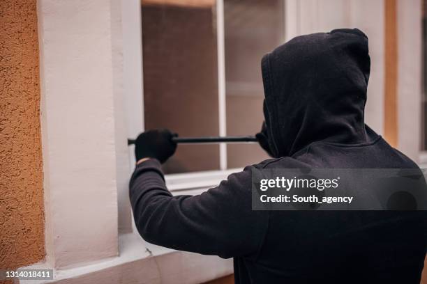 robber trying to brake in house - burglary stock pictures, royalty-free photos & images