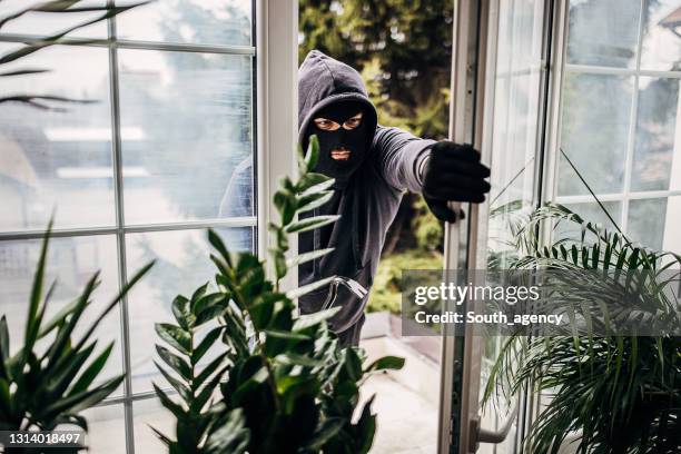 robber breaking in house - burglary stock pictures, royalty-free photos & images