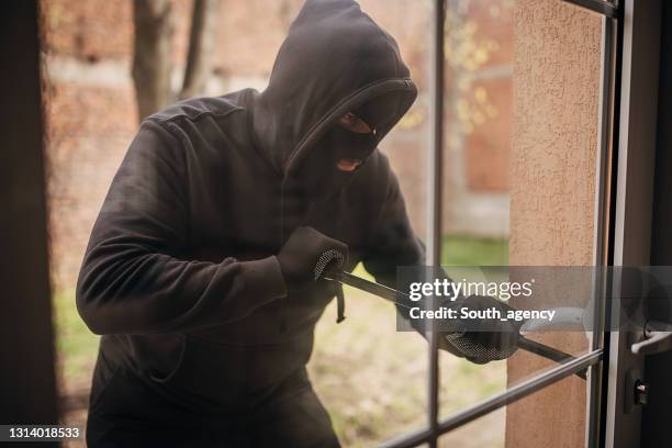 Robber Breaking In Burglar Entering House Photos and Premium High Res Pictures - Getty Images