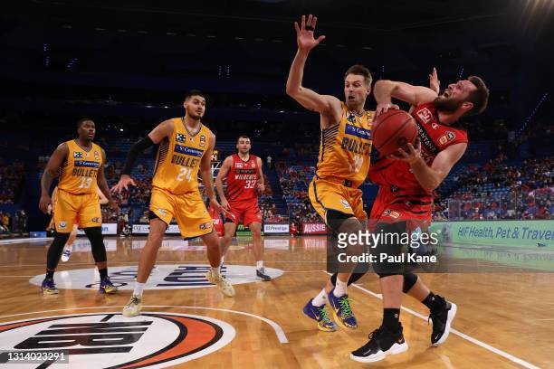 Mitchell Norton of the Wildcats works to the basket against Nathan Sobey of the Bullets during the round 15 NBL match between the Perth Wildcats and...