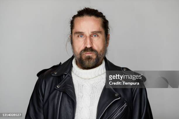 middle-aged man motorcycle rider in a leather jacket. - heavy metal stock pictures, royalty-free photos & images
