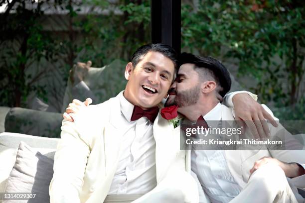 same-sex couple look happy at their wedding ceremony day. - marriage equality stock pictures, royalty-free photos & images