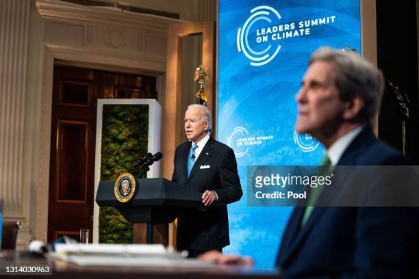 President Joe Biden delivers remarks as Special Presidential Envoy for Climate and former Secretary of State John Kerry listens during day 2 of the...