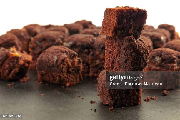 homemade dark chocolate browni pie on black slate board. delicious chocolate pastry dessert cake - fondant cakes stock-fotos und bilder