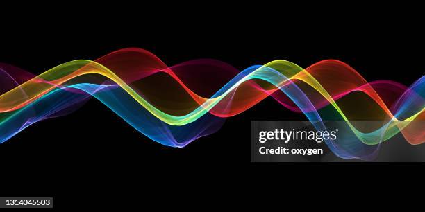 abstract wave swirl colorful magical neon ribbon on black background. energy streams - radiacion electro magnetica fotografías e imágenes de stock