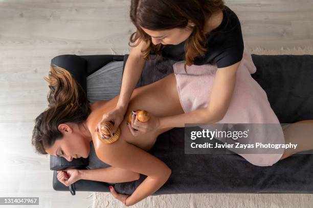 woman on madero therapy treatment for cellulite removal - lymphatic system stock pictures, royalty-free photos & images