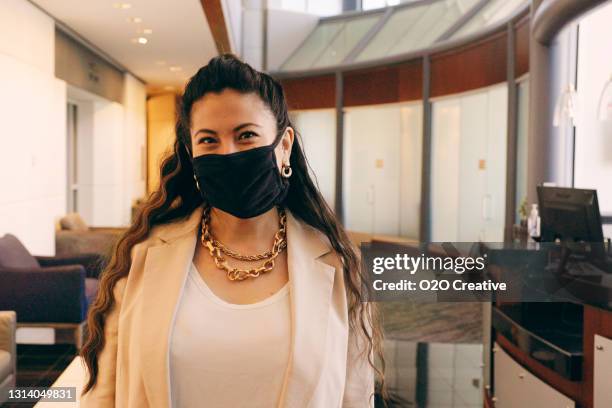 business person taking of a protective facemask - reopening stock pictures, royalty-free photos & images