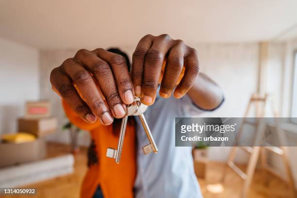 keys of new home in hands on couple - house key hands stock pictures, royalty-free photos & images