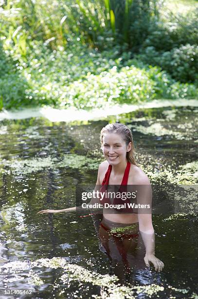 portrait of woman standing in water. - waist deep in water stock pictures, royalty-free photos & images