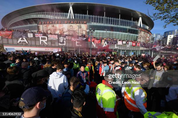 Man is stretchered through the crowd after falling from an awning onto his head during a protest against the club's owner Stan Kroenke ahead of the...