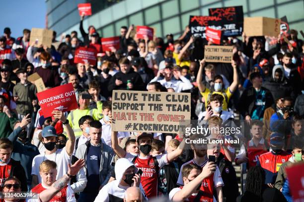 Arsenal fans chant and hold placards during a protest against the club's owner Stan Kroenke ahead of the Premier League match between Arsenal and...