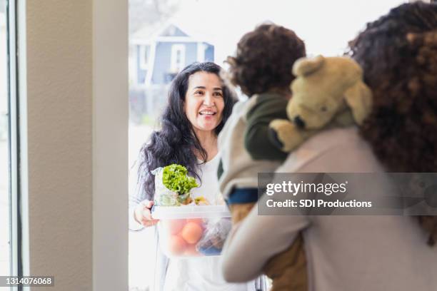 mature adult mom brings groceries to sick daughter and grandson - carrying gifts stock pictures, royalty-free photos & images