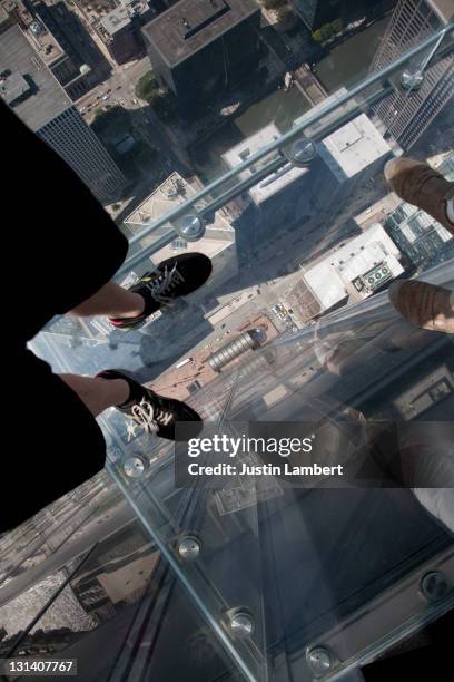 looking at feet through glass at willis tower - willis tower stock pictures, royalty-free photos & images