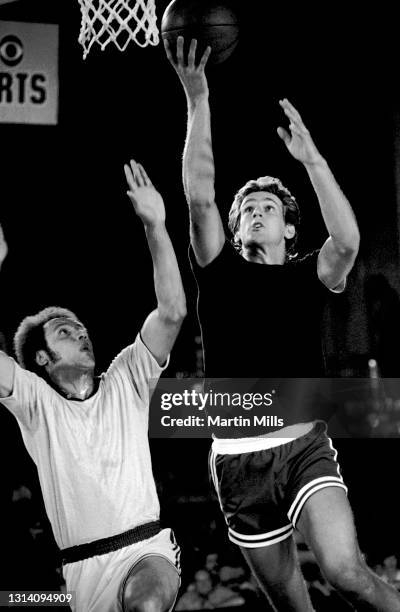 Player of the Phoenix Suns Paul Westphal goes for the lay-up as former NBA player Lenny Wilkens defend during the 3 on 3 Celebrity Basketball...