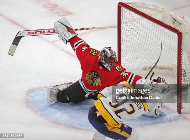 Malcolm Subban of the Chicago Blackhawks makes a glove save on a shot by Ryan Johansen of the Nashville Predators at the United Center on April 23,...