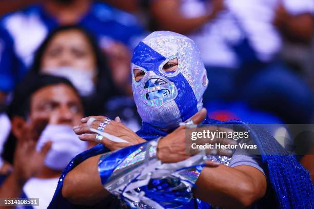 Fan of Puebla wearing a wrestling mask cheers during the 16th round match between Puebla and Pumas UNAM as part of the Torneo Guard1anes 2021 Liga MX...