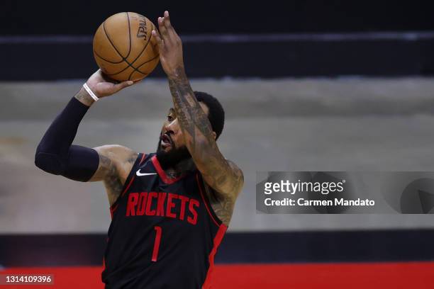 John Wall of the Houston Rockets shoots a three point basket during the third quarter against the Los Angeles Clippers at Toyota Center on April 23,...