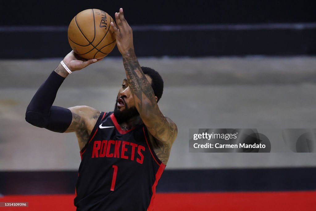 John Wal Rockets John Wall of the Houston Rockets shoots a three point basket during ...
