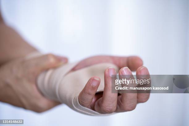 wrist pain - wrapping arm stock pictures, royalty-free photos & images