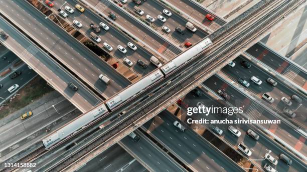 aerial top view of road intersection complex roundabout at day. - green bridge over trees stock pictures, royalty-free photos & images
