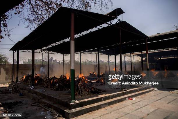 General view of multiple burning funeral pyres of patients who died of the Covid-19 coronavirus disease at a crematorium on April 24, 2021 in New...