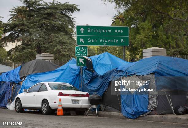 Homeless veterans are housed in 30 tents on a sidewalk along a busy San Vicente Boulevard outside the Veteran's Administration campus in West Los...