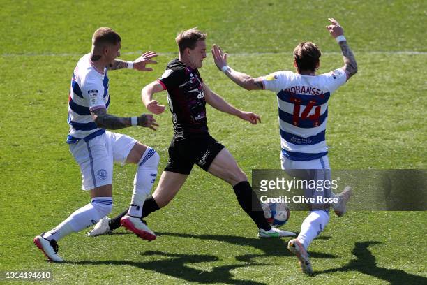Oliver Skipp of Norwich City battles for possession with Jordy De Wijs and Stefan Johansen of Queens Park Rangers during the Sky Bet Championship...