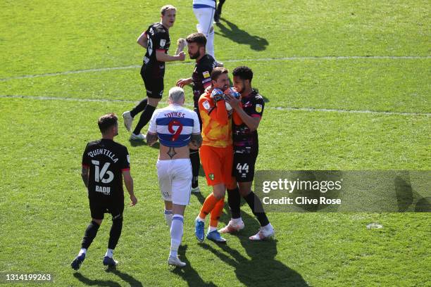 Tim Krul and Andrew Omobamidele of Norwich City celebrate as Lyndon Dykes of Queens Park Rangers misses from the penalty spot during the Sky Bet...