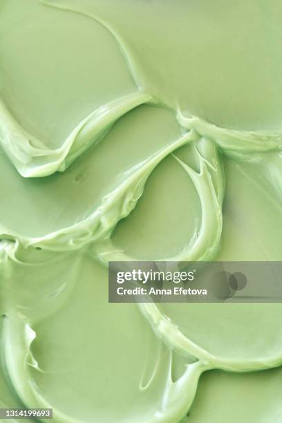 texture of appetizing smears of pistachio ice cream. pastel green background. flat lay style - mint ice cream stock pictures, royalty-free photos & images