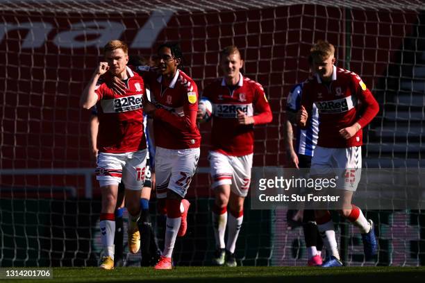 Duncan Watmore of Middlesbrough celebrates with Djed Spence after scoring their team's third goal during the Sky Bet Championship match between...
