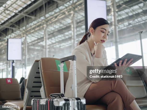 young asian female passenger at airport. - business travel asian stock pictures, royalty-free photos & images