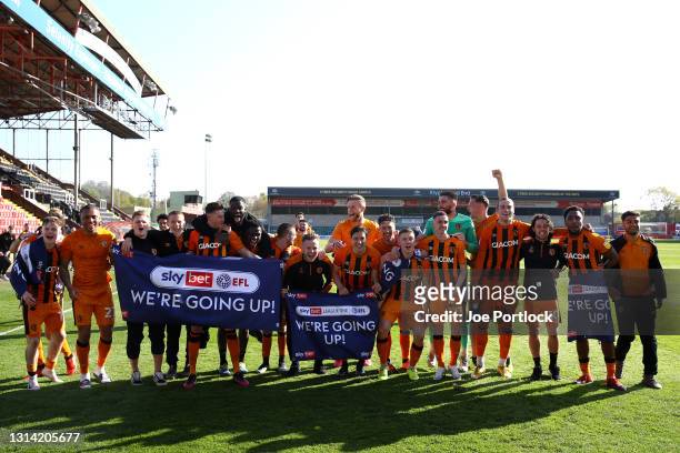 Players of Hull City celebrate on the final whistle as they are promoted to the Championship during the Sky Bet League One match between Lincoln City...