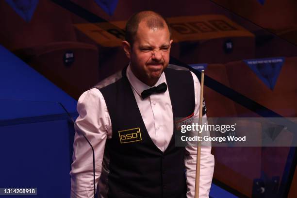 Barry Hawkins of England reacts during the Betfred World Snooker Championship Round Two match between Barry Hawkins of England and Kyren Wilson of...