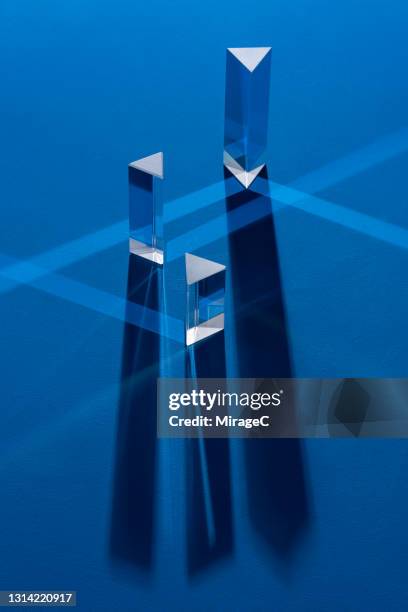 triangular prism refracting light beam - triple lens stock pictures, royalty-free photos & images