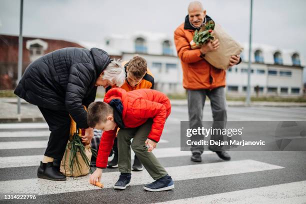 crosswalk - grandma picking up groceries stock pictures, royalty-free photos & images