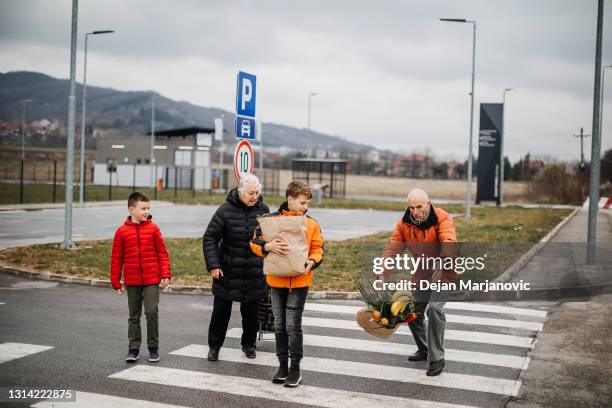 crosswalk - woman walks down street stock pictures, royalty-free photos & images