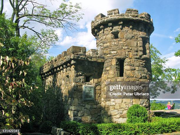 The back and southern side of the Women's Federation Monument in Alpine, NJ as seen when approaching from the Palisades Parkway. A young woman sits...