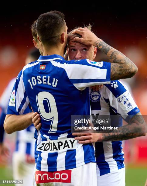 John Guidetti of Deportivo Alaves celebrates with Joselu after scoring their sides first goal during the La Liga Santander match between Valencia CF...