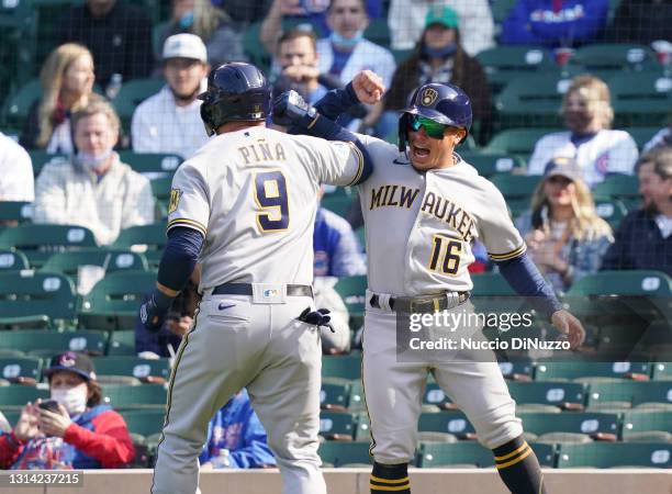 Manny Pina of the Milwaukee Brewers is congratulated by Kolten Wong following his two run home run during the seventh inning of a game against the...