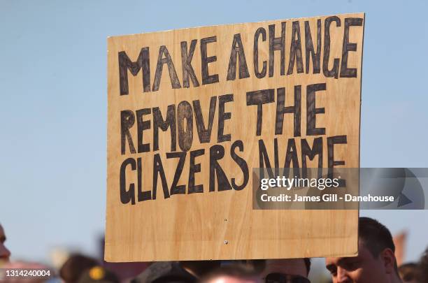 Placard is seen as Manchester United supporters protest against the Glazer ownership during a protest against the club's ownership, outside Old...