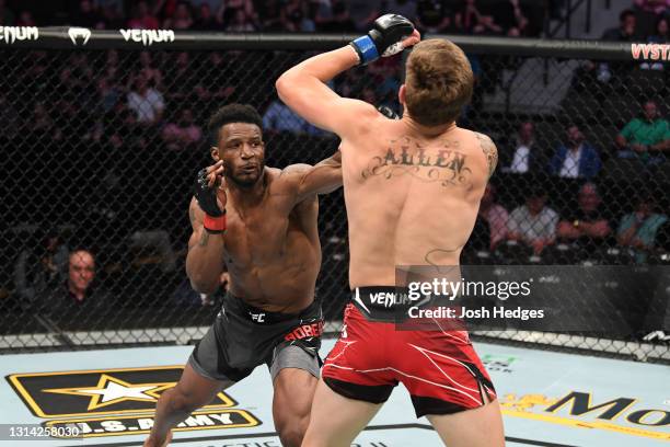 Karl Roberson punches Brendan Allen in their middleweight bout during the UFC 261 event at VyStar Veterans Memorial Arena on April 24, 2021 in...