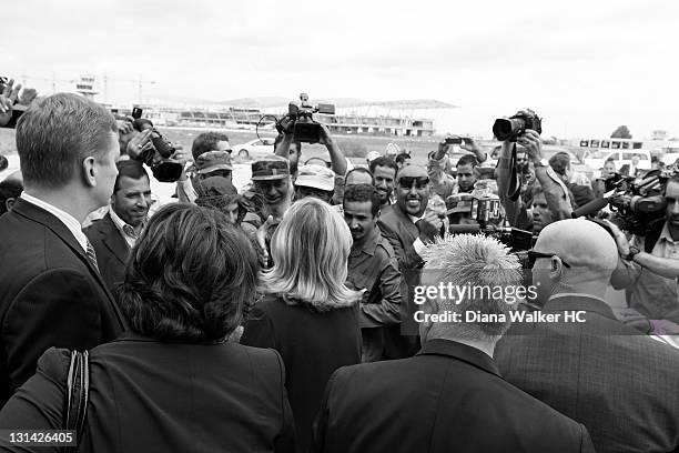 Secretary of State Hillary Clinton greeting the National Transitional Council officials at the steps of the plane upon her arrival is photographed...