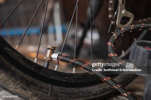 filling bicycle tires with air pump - air pump stock pictures, royalty-free photos & images