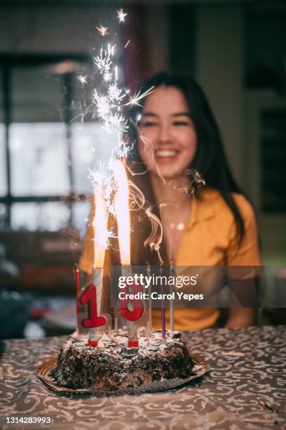 latina teenager celebrating her 18 birthday at home - pre-birthday stock pictures, royalty-free photos & images