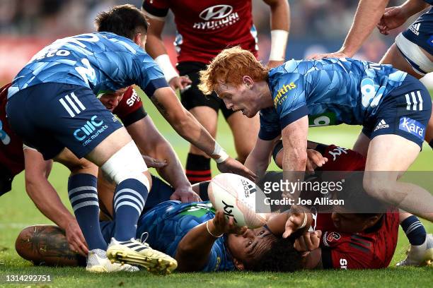 Ofa Tu'ungafasi of the Blues passes the ball back to Finlay Christie of the Blues anbd Otere Black of the Blues during the round nine Super Rugby...