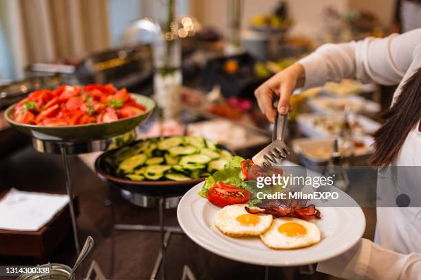 choosing breakfast at restaurant buffet - buffet imagens e fotografias de stock